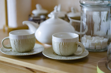 Set of new white dishes on wooden table, indoors