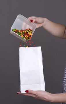 Nurse With Colorful Prescription Drugs Being Placed Into A White Bag