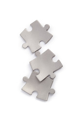 Obraz premium Metal puzzle pieces isolated on white