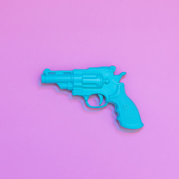 Blue painted gun in Double Exposure. Minimal flat lay.