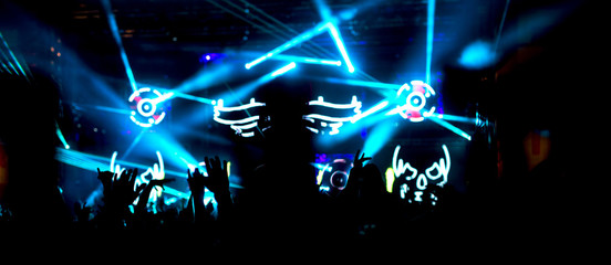 Hands up in the air raised crowd arms. Silhouette people having fun.