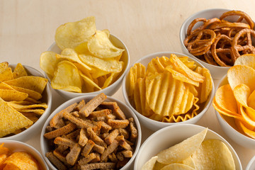 Pretzels in bowls on wooden table from above