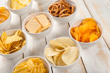 Pretzels in bowls on wooden table from above