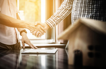 Signing of a real estate contract between buyer and broker.