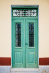 Green old door with glass and forging
