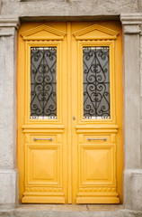 Yellow door with glass and wrought
