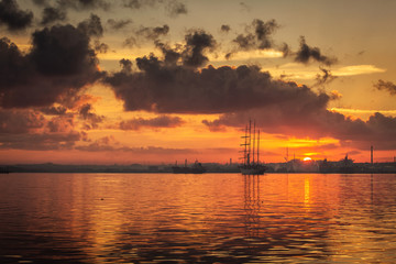 Fototapeta na wymiar Sail boat at sunrise in Havana port, Cuba