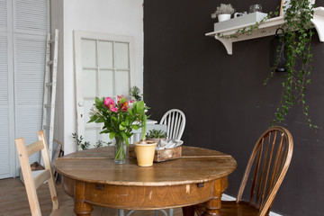 Interior furnished with chair, table with flowers
