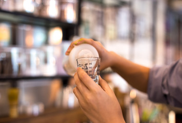 Hand holding measuring glass cup
