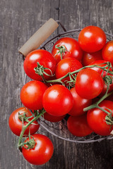 Cherry tomatoes on rustic wooden board