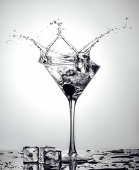 Splash Martini from ice cube in martini glass