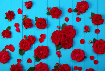 Red roses flowers on blue wood.