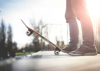 Fototapeta na wymiar Skateboarder standing on the ramp with skateboard.
