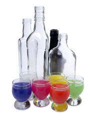 Cocktail in a glass and bottles on white background