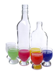 Cocktail in a glass and bottles on white background