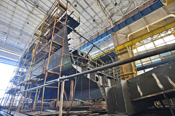 Ship building  inside of shipyard - obrazy, fototapety, plakaty