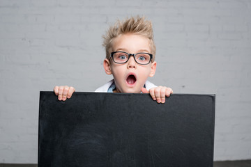 Boy holding blackboard