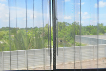 Fototapeta na wymiar Transparent curtain on window, nature view