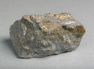 Mineral lead glance (galena) with blende on gray background. One of the most widely distributed sulfide minerals.