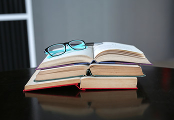 Open book and glasses on wood table. Education background.