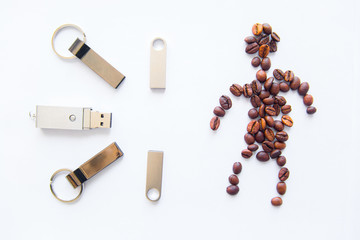 USB stick and coffee beans in human form on a white background.