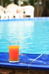 Fototapeta na wymiar Orange Juice Near Water Pool