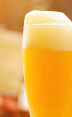 Glass of light beer on a pub background