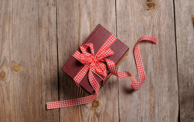 Books wrapped with color ribbon, on wooden table