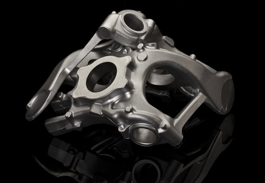 Metal car part over black background