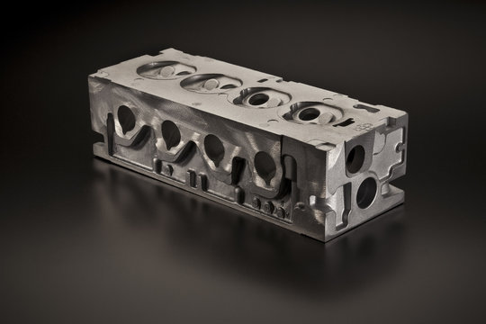 Metal car part over dark background