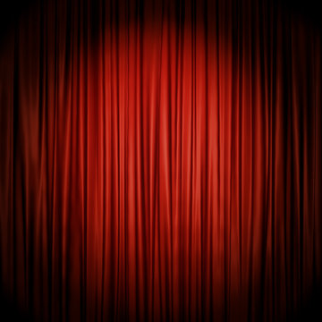 Red stage curtain illuminated by spotlight.