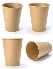 Four paper brown cups for coffee or tea, isolated on white background