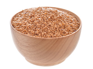 flax seeds heap in wood bowl on a white background