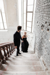 Portrait of a young couple in black suit and dress. Wedding