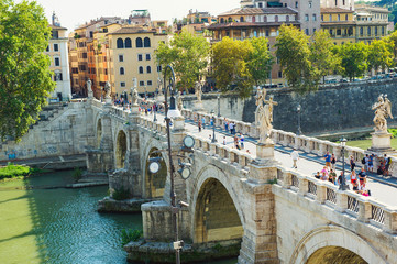 ROME, ITALY - SEPTEMBER 1, 2016: View to Ponte Sant'Angelo over Tiber and tourist strolling along