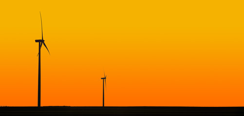 Wind turbines in orange sunset