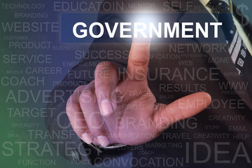 Businessman touching government button on virtual screen