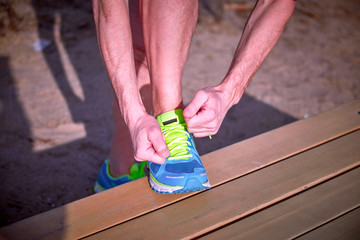 Tying shoelaces on sneakers during class outdoor sports.