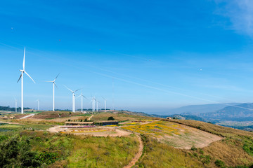 Fototapeta na wymiar Wind Turbines On Blue Sky wind power plant Electricity background