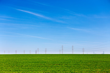 electricity pylons on a farm field