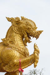 Fototapeta na wymiar Gold Singha statue or lion statue on white background