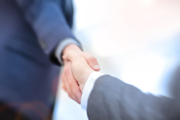 Close up view of business partnership handshake concept.Photo of two businessman handshaking process.Successful deal after great meeting.