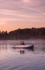 Romantic golden sunset river lake fog loving couple small rowing boat date beautiful Lovers ride during Happy woman man together relaxing water nature around