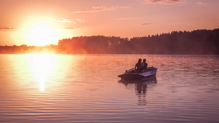 Romantic golden sunset river lake fog loving couple small rowing boat date beautiful Lovers ride during Happy woman man together relaxing water nature around