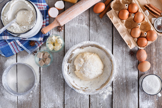 Making dough top view on rustic wood background