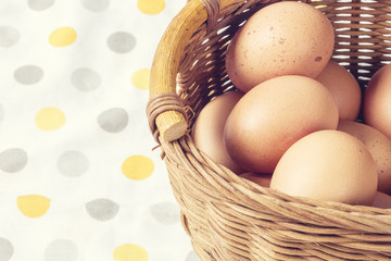 Chicken eggs in a wicker basket, close up