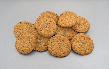 Group of oatmeal cookies on a baking sheet.