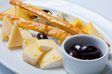 various types of cheese on a white plate