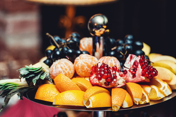sliced fruits on a stand on a white table