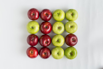 Top view of red and green juicy apples in a row